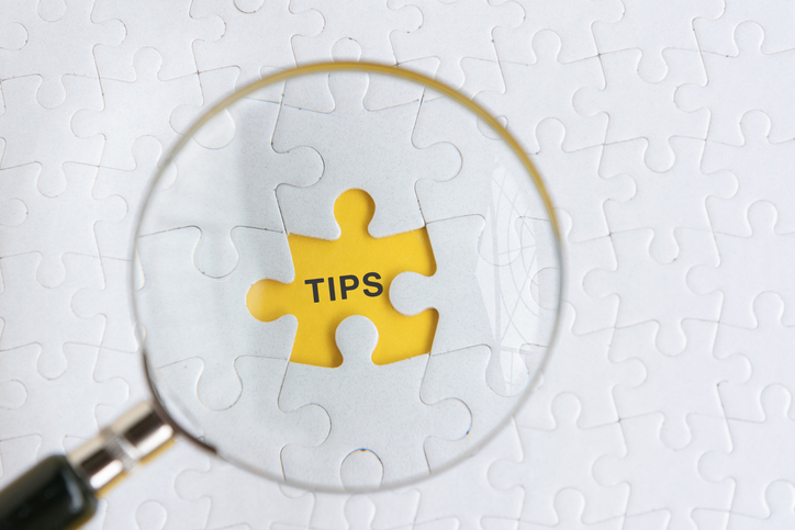 Magnifying glass on the word "TIPS" - Advocacy Campaign 