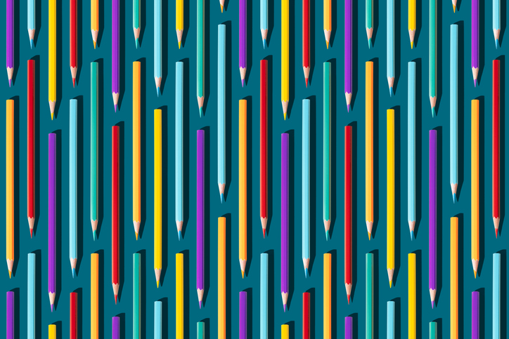 Colored pencils vertical, on dark turquoise background