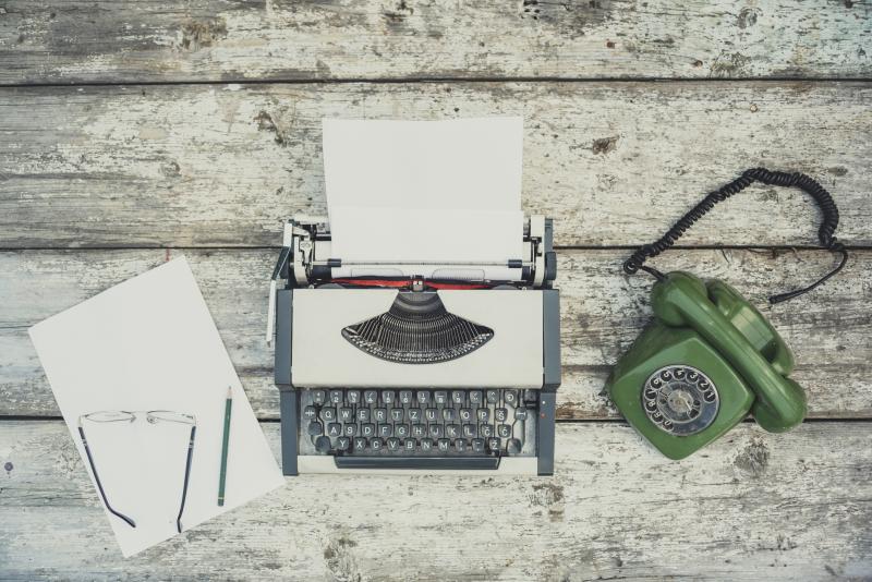 typewriter with a green phone paper and pencil GOTV Script